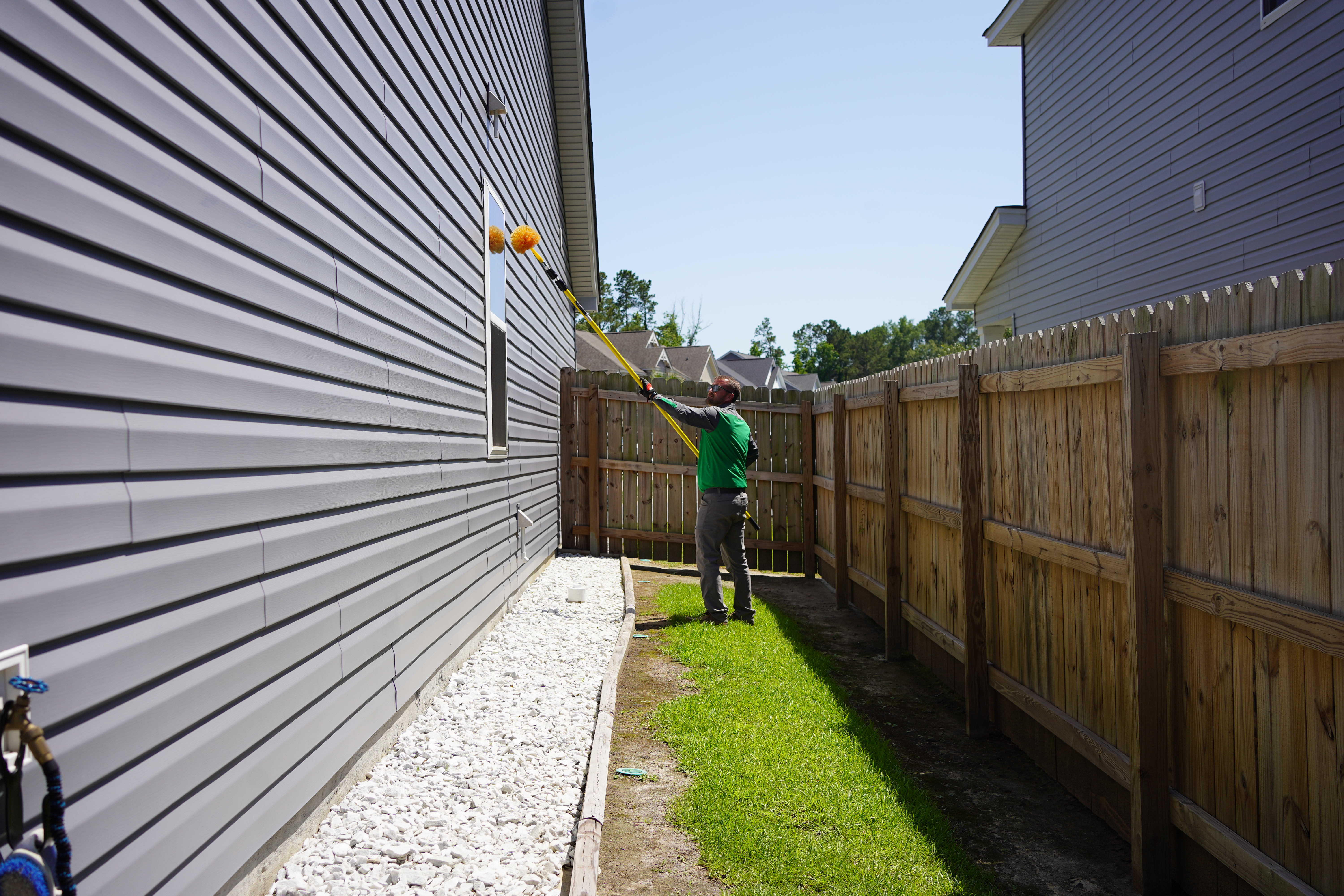 Vinx technician treating new construction suburban home Columbia SC mosquito control