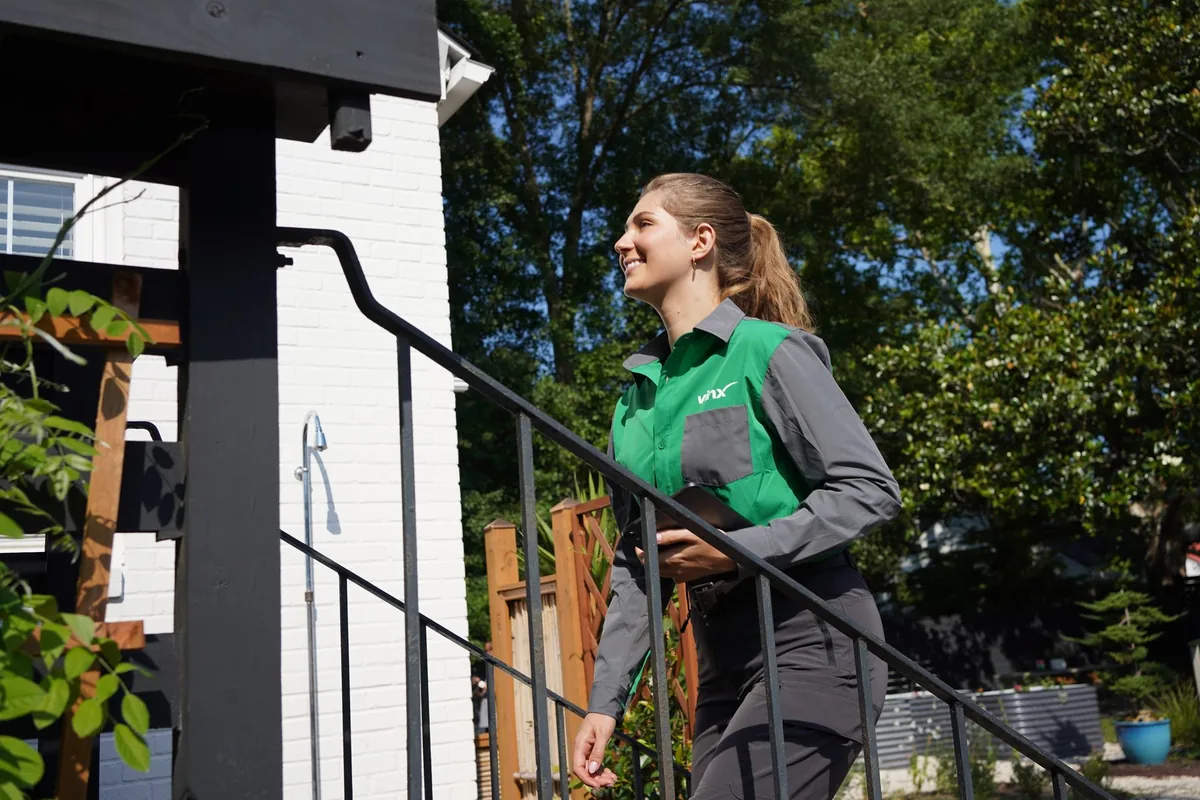Vinx pest control technician arriving at a customer's home with a smile