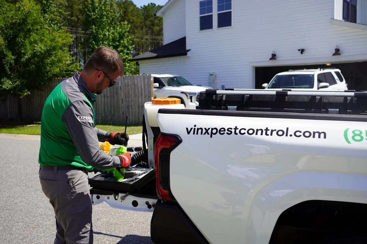 Vinx technician preparing equipment for a warehouse pest control service