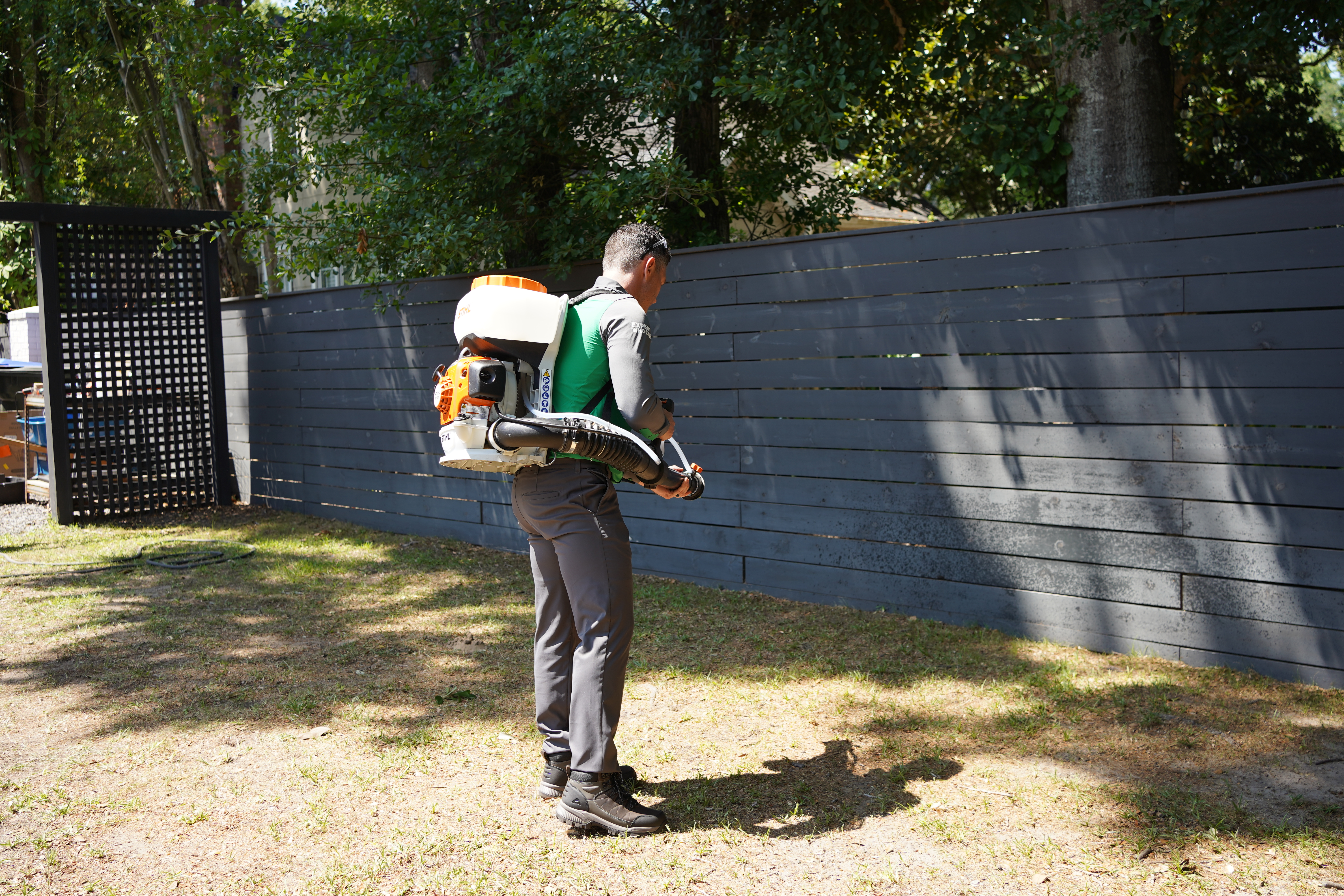 Vinx technician treating fire ant mounds in Raleigh yard